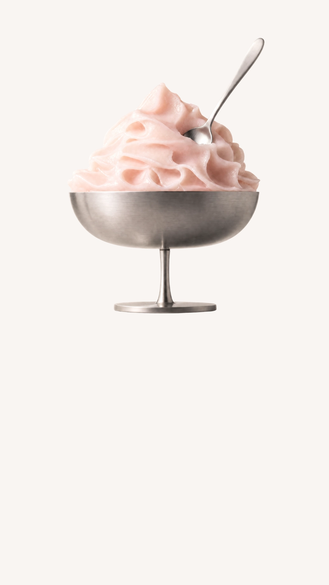 Pink cream served in a metal dish with a small spoon