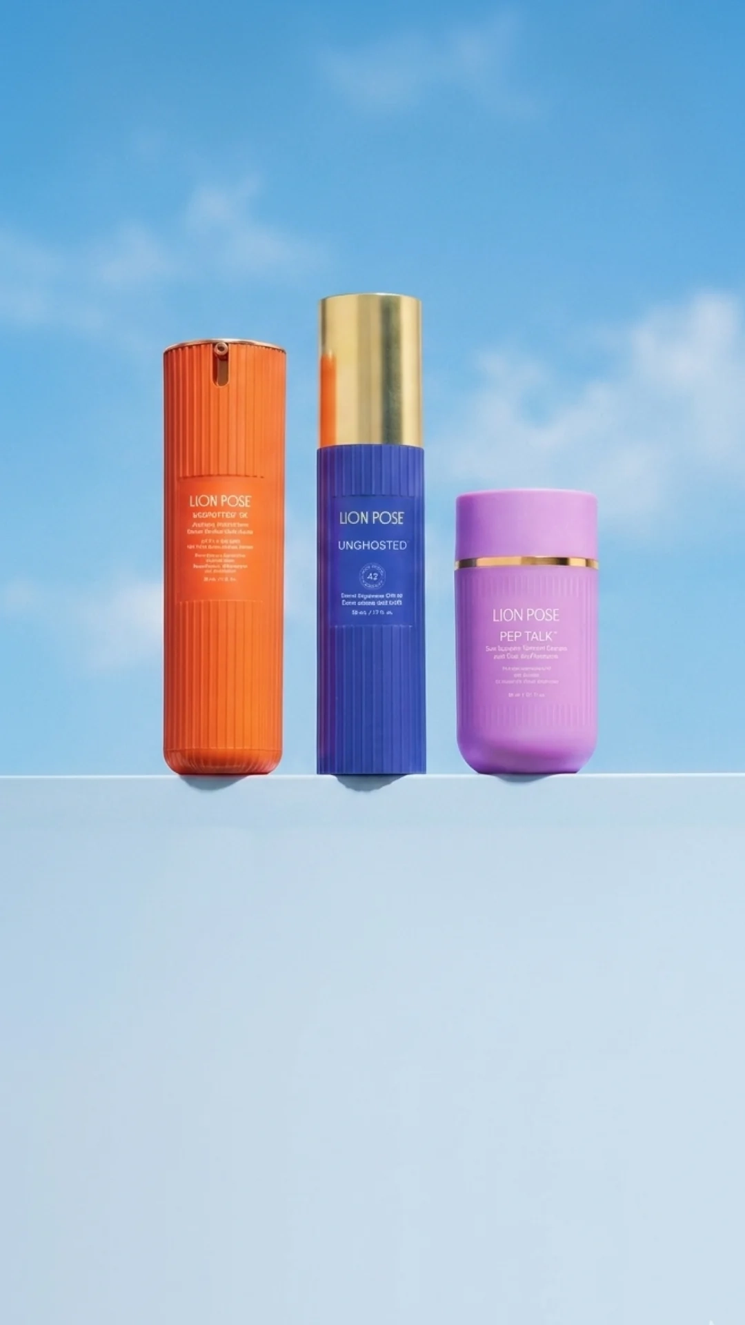 Three Lion Pose bottles on a pale blue sky background